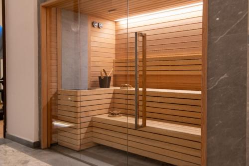 a sauna with wooden walls and a glass door at Palazzo Shedir - The Leading Hotels of the World in Rome