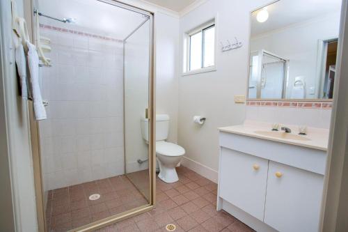 a bathroom with a shower and a toilet and a sink at Tasman Holiday Parks - Hervey Bay in Hervey Bay