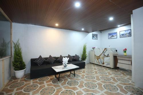 a living room with a couch and a table at The Snow Castle Kufri - A hidden gem in KUFRI in Shimla