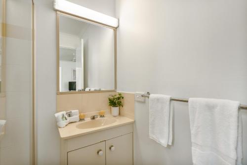 a bathroom with a sink and a mirror at Tasman Holiday Parks - Hervey Bay in Hervey Bay