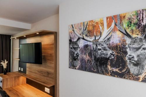 a painting of deer on a wall in a room at Landgasthof zur Linde in Heimbuchenthal