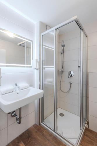 a bathroom with a shower and a sink at Landgasthof zur Linde in Heimbuchenthal