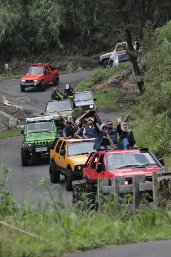 a group of people riding in the back of cars at anemon dieng in Dieng