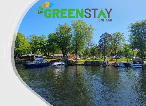 a cover of a magazine with boats in a river at Skyttehusets Camping in Silkeborg