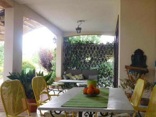a patio with a table with fruit on it at L'albero Del Pepe in Fiano Romano