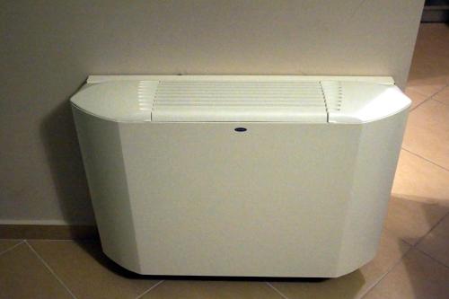 a white refrigerator sitting on top of a floor at Cavos Fokidos in Chiliadou