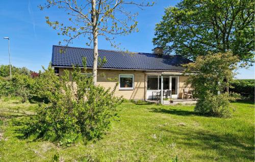 a house with a solar roof on top of a yard at 3 Bedroom Awesome Home In Tranekær in Tranekær