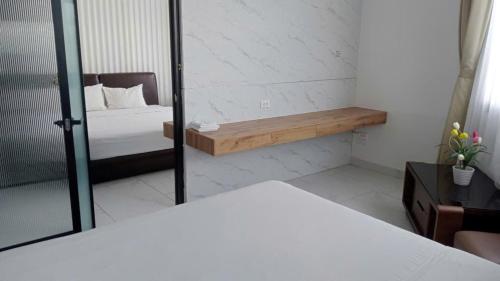 a bedroom with a bed and a mirror at Kellky Homestay Phú Quốc in Phu Quoc