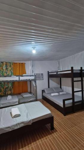 a room with two bunk beds in it at Casetta Homestay Siargao in General Luna