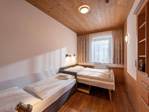 a room with two beds and a window at Apartment in Fügen near Spieljoch Ski Lift in Fügen