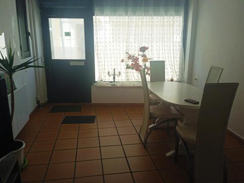 a dining room with a table and a window at chez l'habitant in Lavelanet