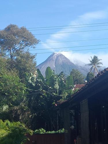 a mountain in the distance with trees and a house at Guest House T in Bedoyo
