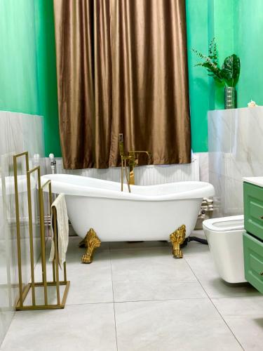 a bathroom with a tub and a shower curtain at LAYA Old City in Bucharest