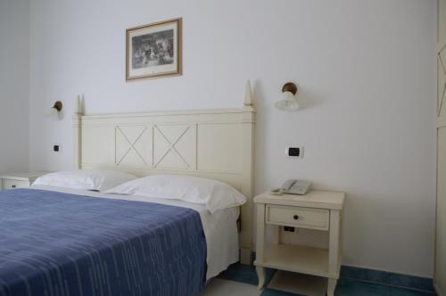 מיטה או מיטות בחדר ב-Mare Blu Residence