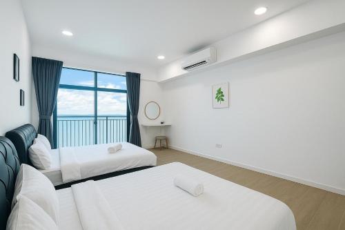 a hotel room with two beds and a window at Baysuites stay haven in Kota Kinabalu