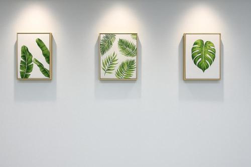 a wall with four pictures of leaves on a wall at Baysuites stay haven in Kota Kinabalu