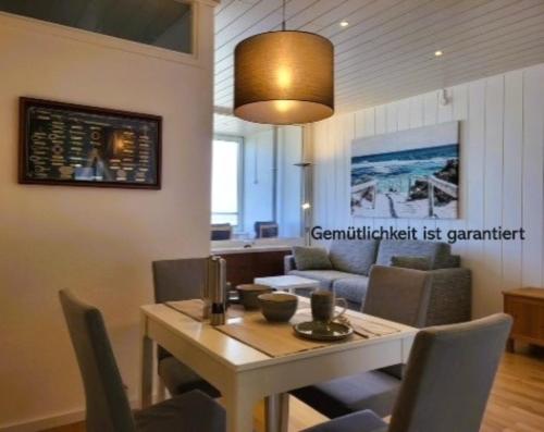 a dining room with a table and chairs at Leuchtfeuer in Wendtorf