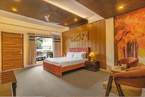a bedroom with a bed and a living room at Maple Resort Chail in Chail