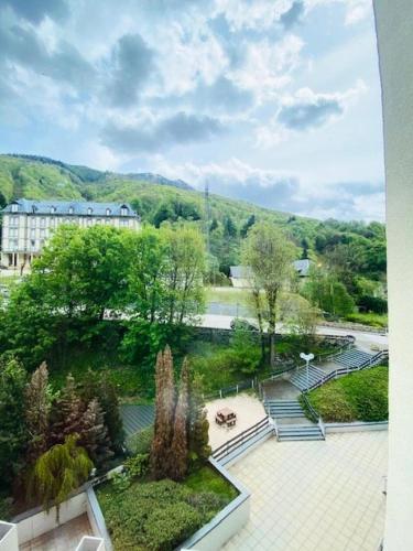 - une vue sur un jardin avec un bâtiment en arrière-plan dans l'établissement Résidence Ayre - Spacieux T2 proche du centre de Barèges MAE-1601, à Barèges