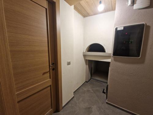 a door to a small room with a sink and a door at B&B Scarpo & Supel in Nona