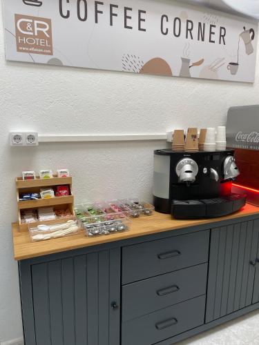 a coffee counter with a coffee maker on top of it at El Faisan C&R Hotel in Arcos de la Frontera