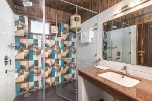 a bathroom with a sink and a shower at Maple Resort Chail in Chail