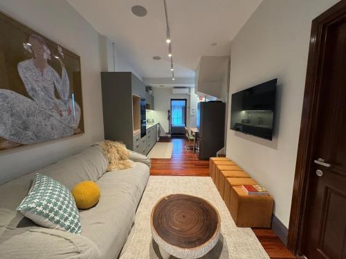 a living room with a couch and a table at Chez Mimi, Elegant City Escape in Sydney