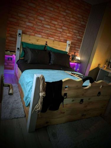 a bedroom with a large bed with a wooden headboard at The Alchemy in Bournemouth