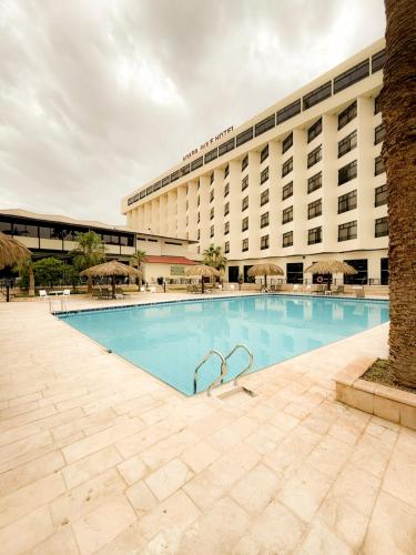 a large swimming pool in front of a hotel at Aqaba Gulf Hotel By FHM in Aqaba