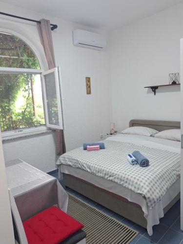 a bedroom with two beds and a window at Room Nena in Senj