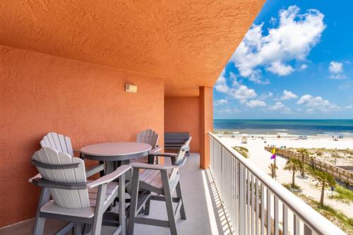 a balcony with a table and chairs and the beach at Buena Vista 403 in Gulf Shores