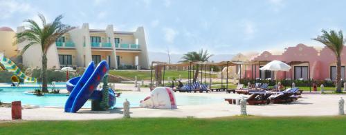 a resort with a pool with slides and chairs at ONATTI Beach Resort in Quseir