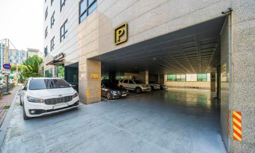a parking lot with cars parked in a parking garage at Wolmido Premiers Hotel in Incheon