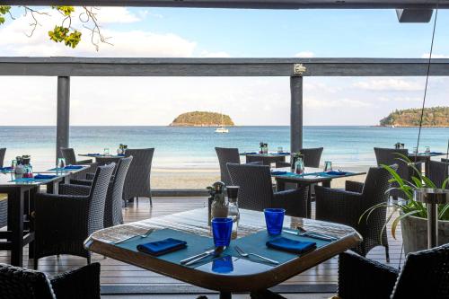 a restaurant with a view of the beach at The Boathouse Phuket-SHA Plus in Kata Beach