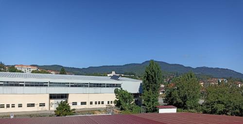 a large white building with mountains in the background at St Jamesway Tuy in Tui