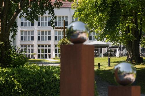 a fence with silver balls in front of a building at Hotel Raphael im Allgäu in Kempten