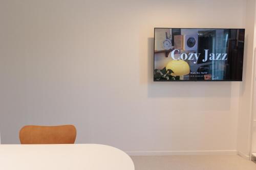 a dining room with a tv on the wall at Wecostay Cheongnyangni in Seoul