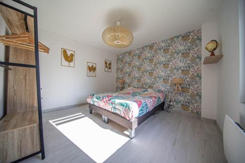 a bedroom with a bed and a wall at Le gîte des Remparts in Vignot