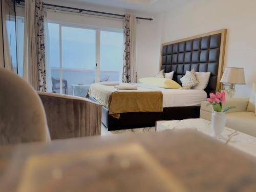 a hotel room with a bed and a couch at Ocean Breeze Negombo- TidesEnd Luxury Beach Apartments in Negombo