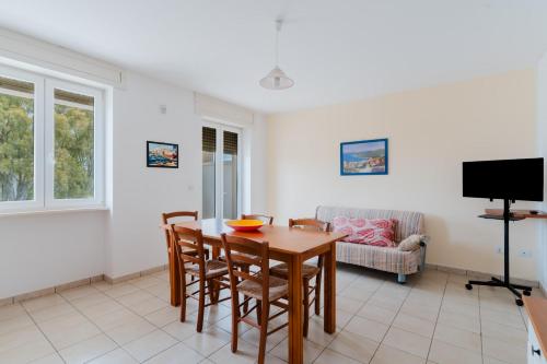 a dining room with a table and chairs at Residence Punta Pizzo in Marina di Mancaversa