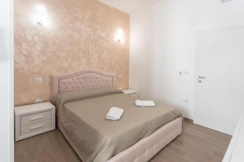a bedroom with a bed with two towels on it at ApartHotel Angelo - Salento Reservation in Racale