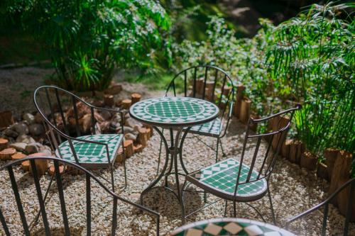 a table and four chairs sitting in a garden at Dahlia Dalat in Xuan An