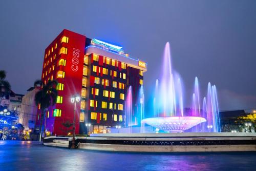 a building with a fountain in front of a building at COSI Vientiane Nam Phu in Vientiane