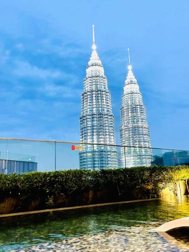 a view of the petronas towers from the water at My Residence Villa Star Klcc in Kuala Lumpur
