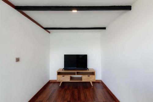 a room with a flat screen tv on a dresser at Faro Cabin Kintamani in Kintamani
