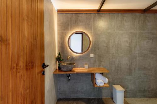 a bathroom with a sink and a mirror at Faro Cabin Kintamani in Kintamani