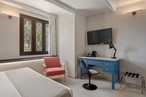 a bedroom with a desk and a tv and a chair at Villa Felicia in Noto