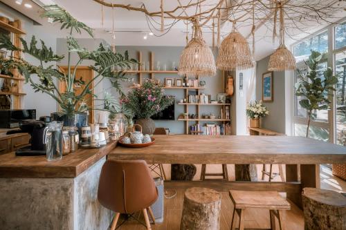 a kitchen with a large wooden table and chairs at Dahlia Dalat in Xuan An