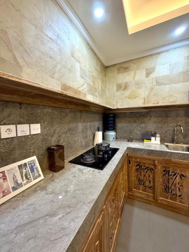 a kitchen with a sink and a counter top at Villa Tenang in Ubud
