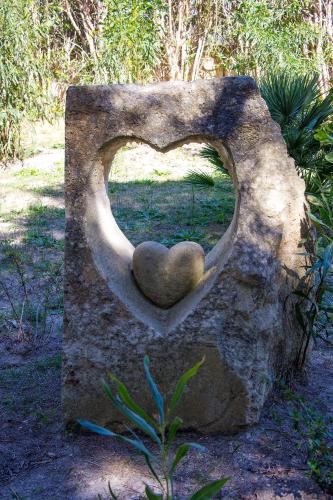 a statue of a heart on a rock at Ecoresort Le Sirene - Caroli Hotels in Gallipoli